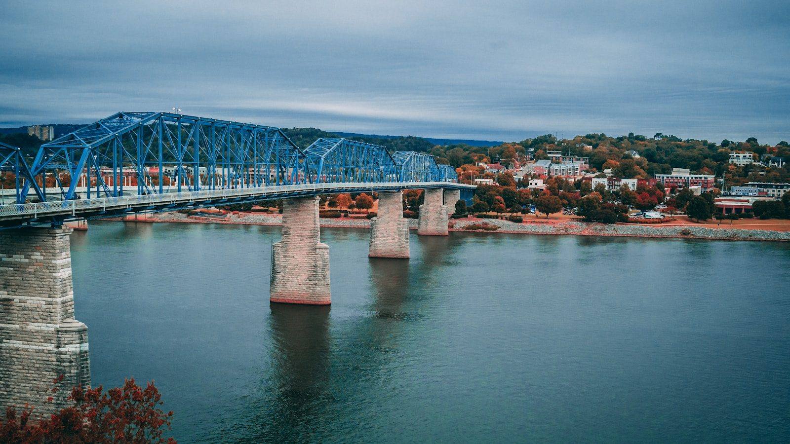 The Walnut Street Bridge crossing the Tennessee River in Chattanooga, with autumn trees along the far bank