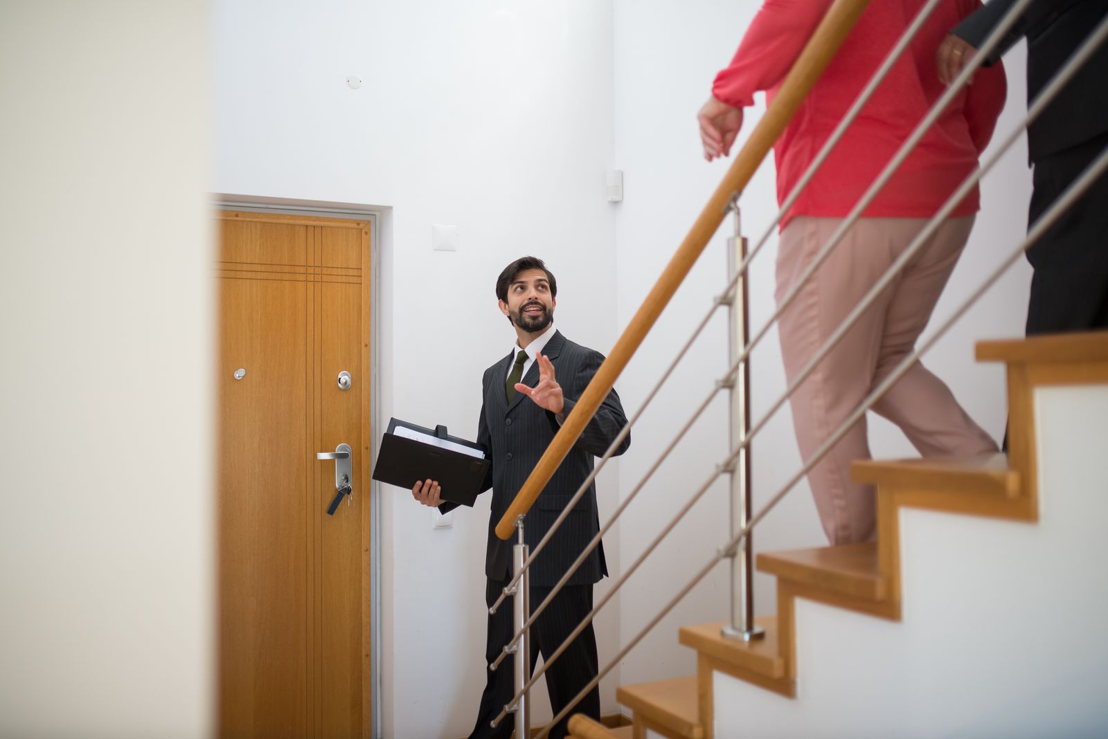 Real estate agent giving a house tour to buyers